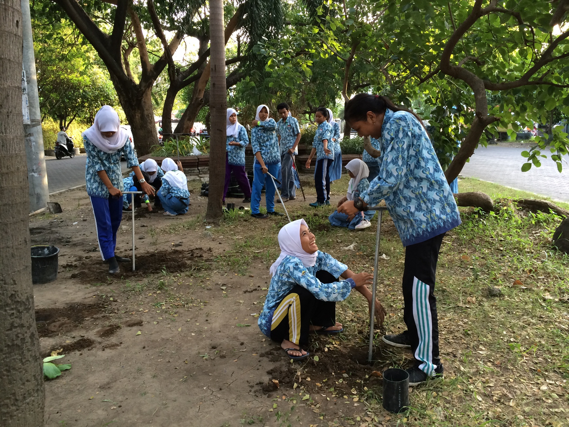 High school students in Surabaya digging biopore holes near their campus on Hari Air (Water Day) - Credit: Danau Tanu