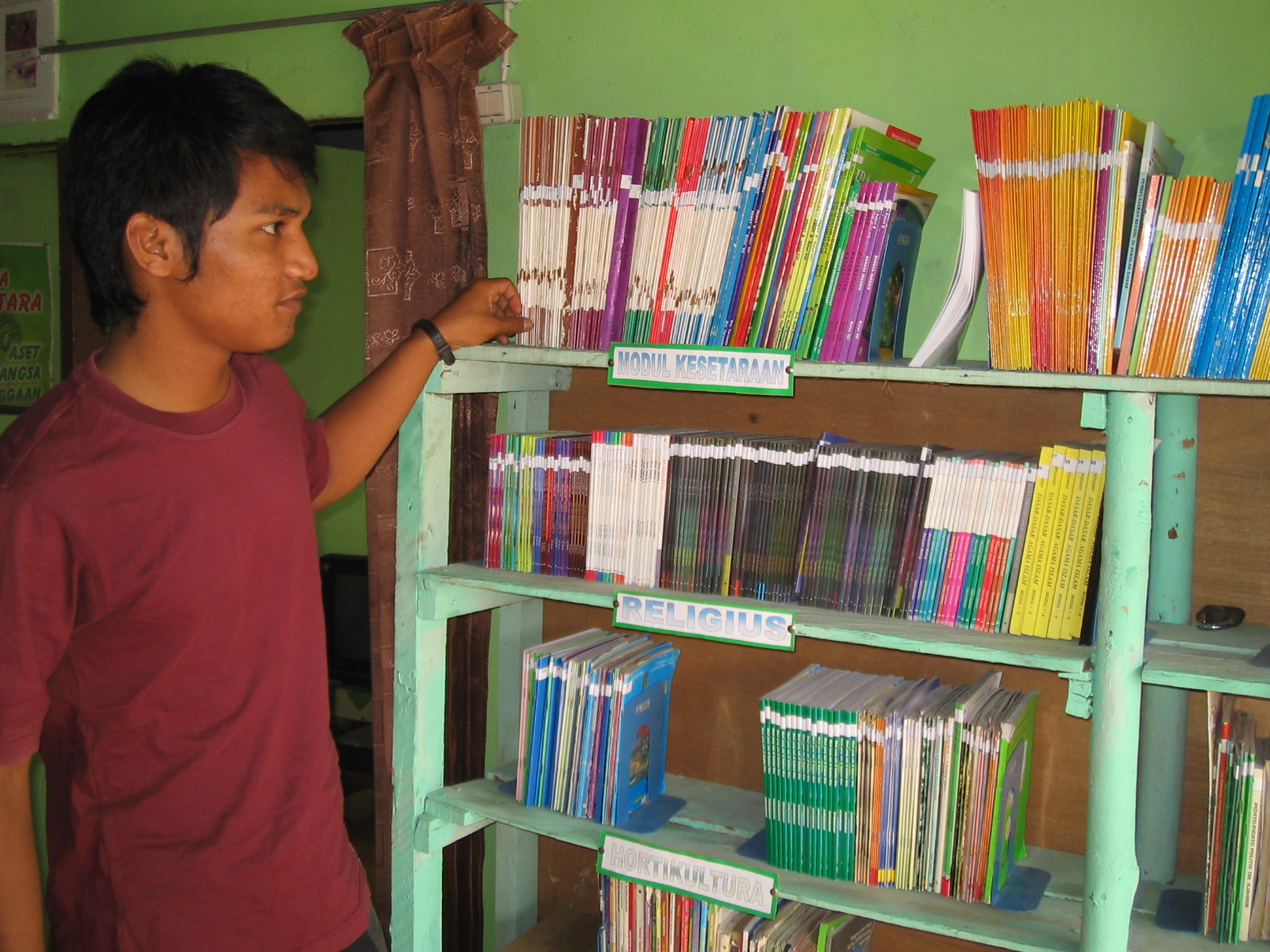Building on his passion for books, this young man engages in irregular work at a community learning centre - Wenty Minza